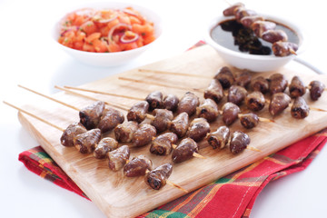 Grilled chicken hearts on skewers