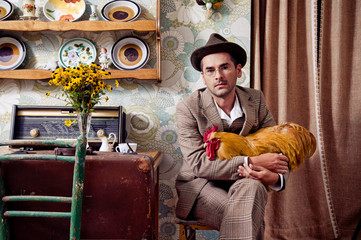 Retro guy holding his rooster © Viktor Pravdica