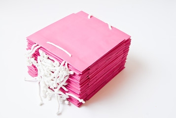 Stack of Pink shopping bags, isolated on white background.