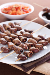 Grilled chicken hearts on skewers