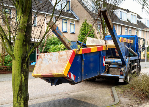 truck delivers waste container