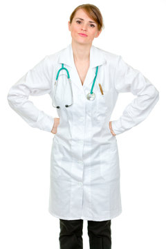 Displeased medical doctor woman holding hands on hips