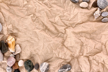 Brown crumpled paper and sea stones
