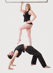 Young Couple Practices Acrobatic Balance