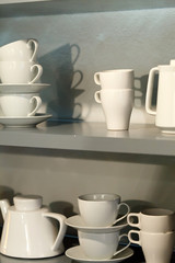 Fototapeta premium white cups on the shelf