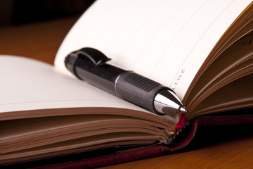 notebook pen paper table busy