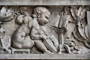 Child musician on a frieze