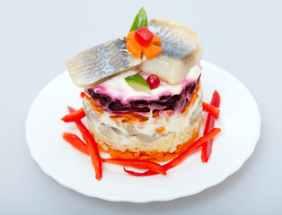 Salad of vegetables and fish herring