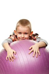 Naklejka premium Cute boy playing with fit ball