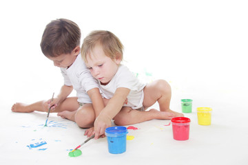 two children painting over white