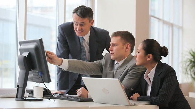 Boss checks the work of colleagues