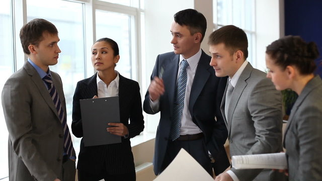 Businessteam discussing paper and consulting at meeting