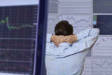 Exchange broker looks at the monitor