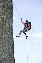 Rock climber rappelling.