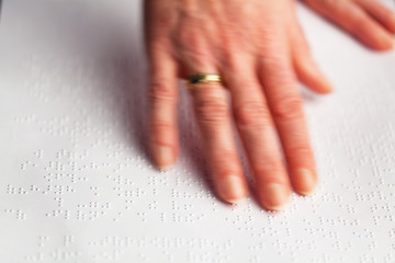 Blindenschrift und Finger.