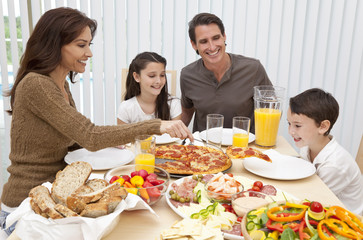 Obraz na płótnie Canvas Parents Children Family Eating Pizza & Salad At Dining Table