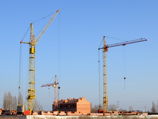 Fototapeta na wymiar Cranes and building under construction