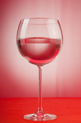 Water in the glass against gradient background