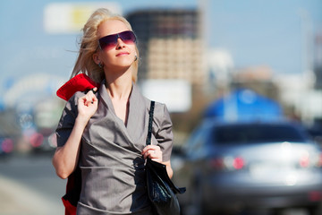 Young woman against a city traffic