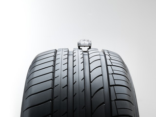 Summer high performance tyre with an old toy car on top