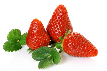 three ripe strawberries with big leaves on white background - 31330355