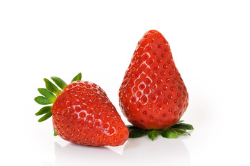 two ripe strawberries with big leaves on white background