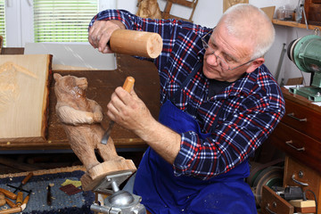 Woodcarver work in his workshop