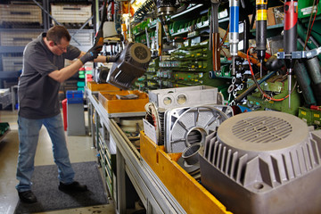 skilled industrial worker, mounting electric motors