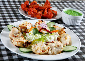 Seekh kebab with salad and tandoori fish
