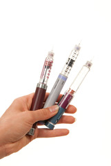 Diabetes insulin  Hand with syringes pen injector