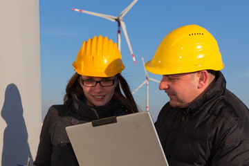 Two Engineers in Wind Turbine Power Generator Station