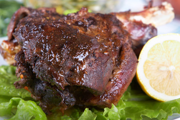 Roast leg of lamb on decorated table