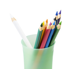 Color pencils in a glass on a white background