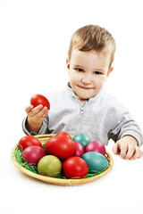 Fototapeta na wymiar Little boy playing with easter eggs in basket