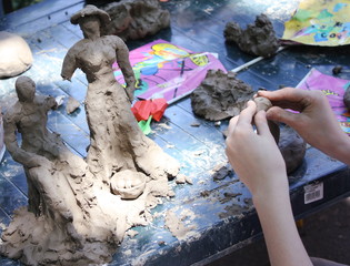 Child building clay statues