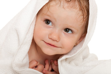 Closeup portrait of cheerful little girl in the white towel