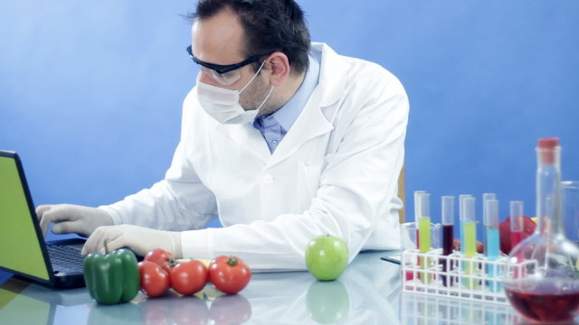 Male scientist in laboratory working on laptop