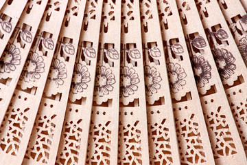 Macro shot of a fan with floral pattern © zest_marina