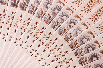 Macro shot of a fan with floral pattern © zest_marina