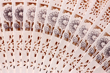 Macro shot of a fan with floral pattern © zest_marina