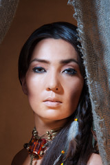 American Indian woman looking from the tent