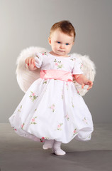 little girl in an elegant dress with wings of an angel