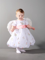 little girl in an elegant dress with wings of an angel