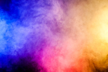 Red, Yellow and blue smoke  on black background