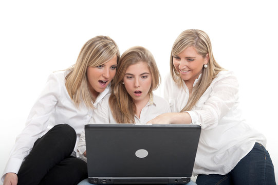 Impressed girls with laptop