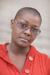 Headshot of a bald woman with glasses