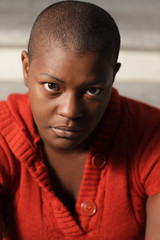 Headshot of a woman with a shaved head