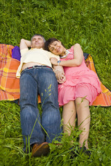 Fototapeta premium Couple sleeping on grass