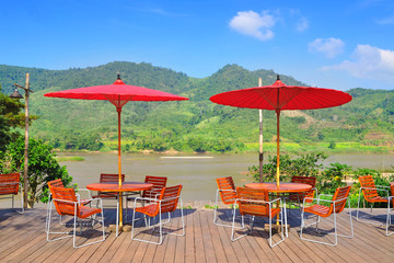 outside chair with red umbrella