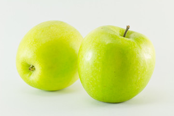 Two green apples isolated on white background